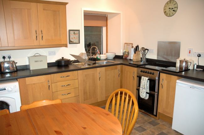 The kitchen in Bruaich Cottage has recently been re-fitted to a high standard with modern kitchen units and appliances.